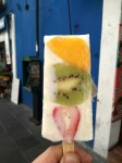 Natural yogurt ice creams with fruit slices - kiwi, mango and strawberry.