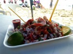 Acapulco - Ceviche with fish and seafood - prawns, squiand octopus. Served with half lime, red salsa, onions and tomatoes.