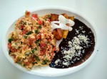 Huevos revueltos a la Mexicana con platanos fritos y frijoles. Mexican style scrambled eggs with onion, tomatoes and habanero, served with fried beans and deep fried bananas topped with cream.