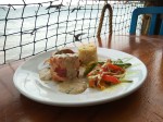 Chicken Malecon - chicken breast filled with two cheeses and spinach; wrapped in bacon; nested on a layer of a mushroom sauce and served with rice and vegetables.
