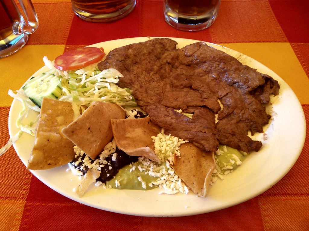 Bistec al gusto acompanado con frijoles, guacamole y ensalada.