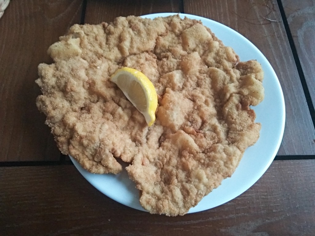 Enormous Wiener schnitzel with French fries and a salad mix.