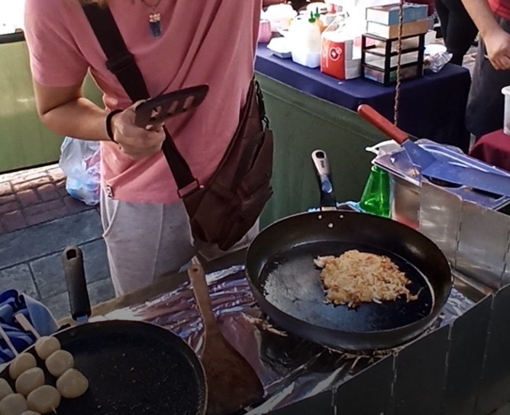 Frying Japanese okonomiyaki
