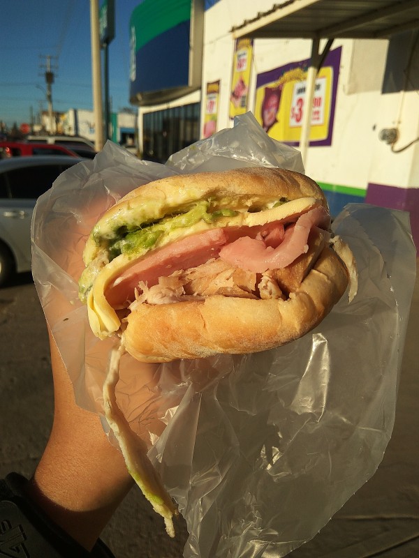Mexican Torta with ham, cheese, cabbage and avocado.