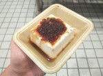 Hard tofu with soy sauce and bonito flakes - fermented, dried and smoked fish flakes.