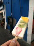 Natural yogurt ice creams with fruit slices - kiwi, mango and strawberry.