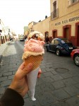 Three scoops of homemade ice creams - walnut, strawberry and nougat.