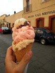 Three scoops of homemade ice creams - walnut, strawberry and nougat.