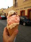 Three scoops of homemade ice creams - walnut, strawberry and nougat.