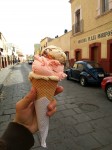 Three scoops of homemade ice creams - walnut, strawberry and nougat.