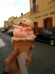 Three scoops of homemade ice creams - walnut, strawberry and nougat.