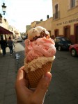 Three scoops of homemade ice creams - walnut, strawberry and nougat.