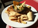 Nachos with guacamole served with cheese.