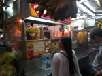 A street stall with fried, spiral potatoes - espiropapas and with deep fried bananas - platanos fritos.