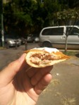 Mexican empanadas con carne - Mexican fried dumplings with meat. Served with white cabbage and topped with cream.