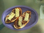 Toasted bread with fried beans and topped with a slice of cheese - Cancun, guesthouse.