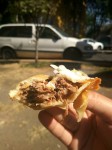 Mexican empanadas con carne - Mexican fried dumplings with meat. Served with white cabbage and topped with cream.