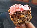 Strawberry ice creams in chocolate with dried fruits, nuts, shredded coconut and with a big strawberry at the bottom. Strawberry ice creams in chocolate with dried fruits, nuts, shredded coconut and with a big strawberry at the bottom.