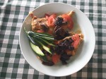Chicken breast with fried tomatoes and mushrooms fried on butter.