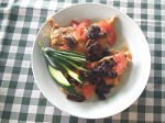 Chicken breast with fried tomatoes and mushrooms fried on butter.