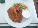 Bécsi Szelet with baked potatoes and garlic sauce.