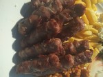 Ćevapčići rolled in bacon slices.