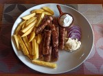 Montenegrin Ćevapi with cream and fries Montenegrin Ćevapi with cream and fries