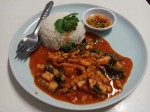 Red curry paste with fried young coconut and basil leaves served with rice