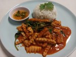 Red curry paste with fried young coconut and basil leaves served with rice
