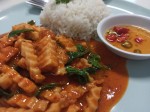 Red curry paste with fried young coconut and basil leaves served with rice