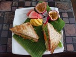 Toasts with eggs and vegetables served with fresh fruits