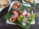 Hard boiled eggs with toasts, vegetables and fruits