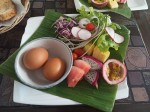 Hard boiled eggs with toasts, vegetables and fruits