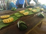 Sweet and juicy pineapples and a banana leaf lunch box for a meal during the jungle trekking in Thailand