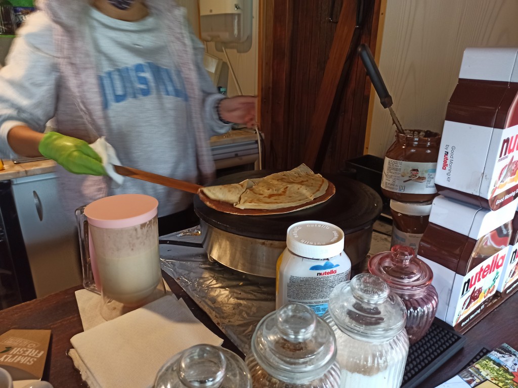 Fold the pancake by putting the empty side on the one with Nutella and bananas. Fold the pancake by putting the empty side on the one with Nutella and bananas.