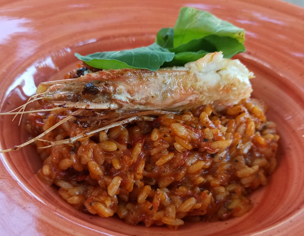 Red rice risotto with prawns and parmesan cheese