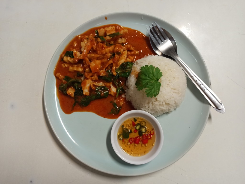 Red curry paste with fried young coconut and basil leaves served with rice Red curry paste with fried young coconut and basil leaves served with rice