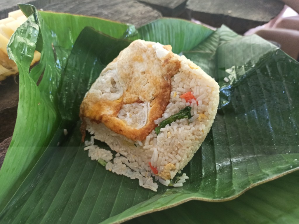 Banana leaf lunch box with fried rice and egg for the first meal in the jungle during the trekking in Thailand