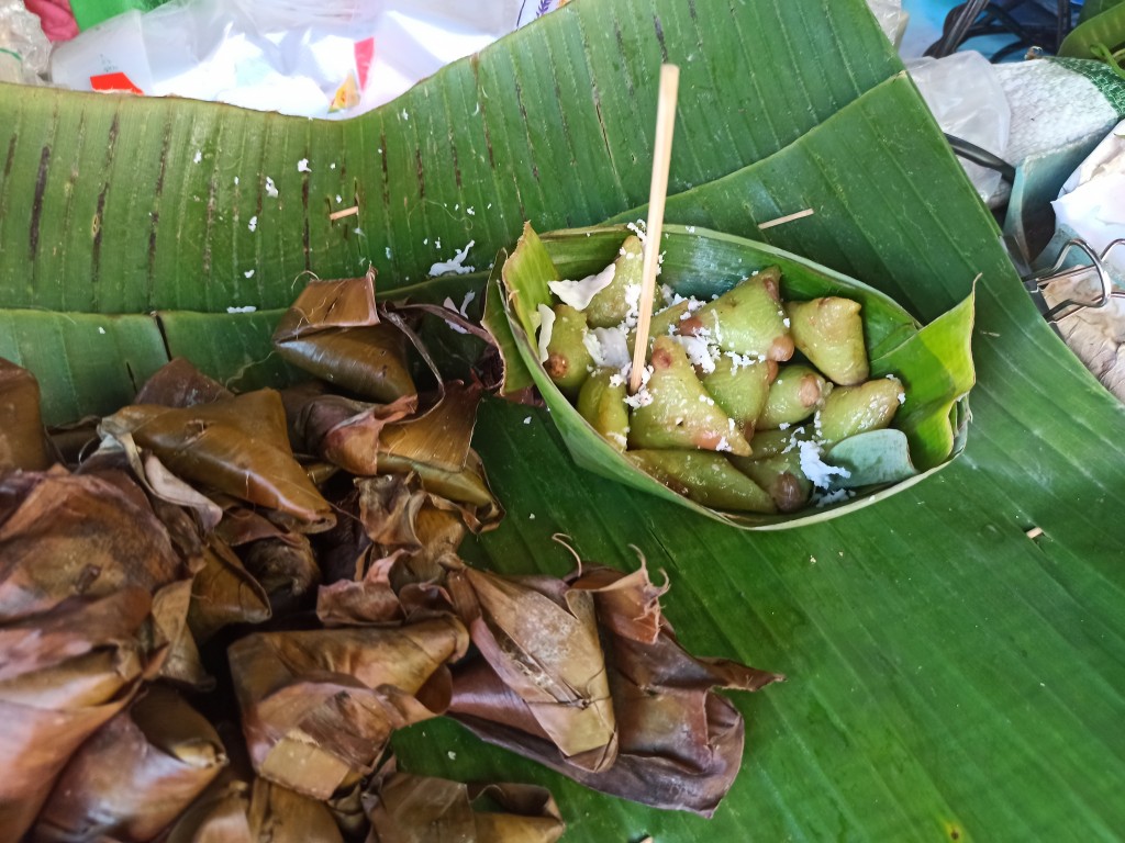 Sweet green sticky rice with coconut in a banana leaf Sweet green sticky rice with coconut in a banana leaf